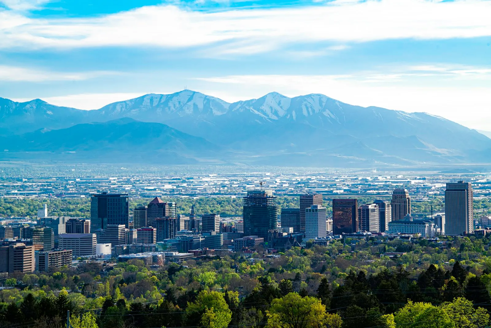 The Salt Lake City skyline with the snow-capped Wasatch mountains behind it